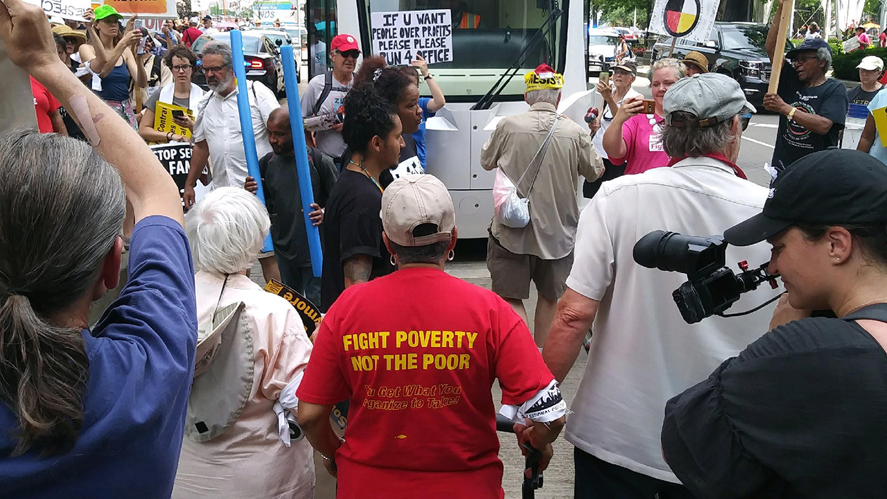Bill Wylie-Kellermann and Marian Kramer lead a nonviolent direct action with the Michigan Poor People’s Campaign, blocking the M-1 rail in downtown Detroit on June 18, 2018. — Tommy Airey