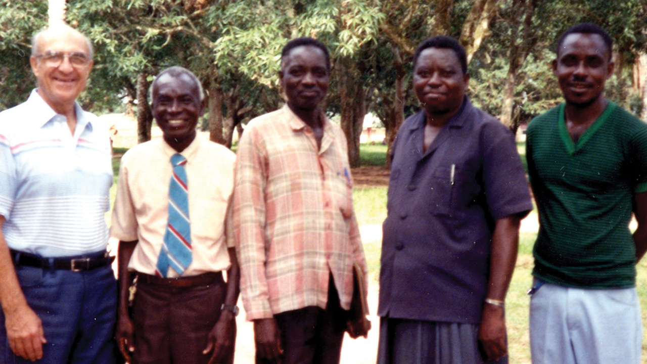 Earl Roth, left, greets Chief Nyanga, second from right, and other friends on an administrative trip to Congo in 1993. — Mennonite Church USA Archives