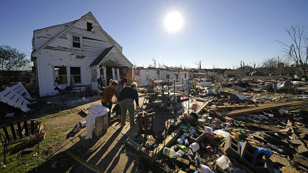 Volunteers salvage possessions from the destroyed home of Martha Thomas in Mayfield, Ky., on Dec. 13 in the aftermath of tornadoes that tore through the region several days earlier. — Gerald Herbert/AP