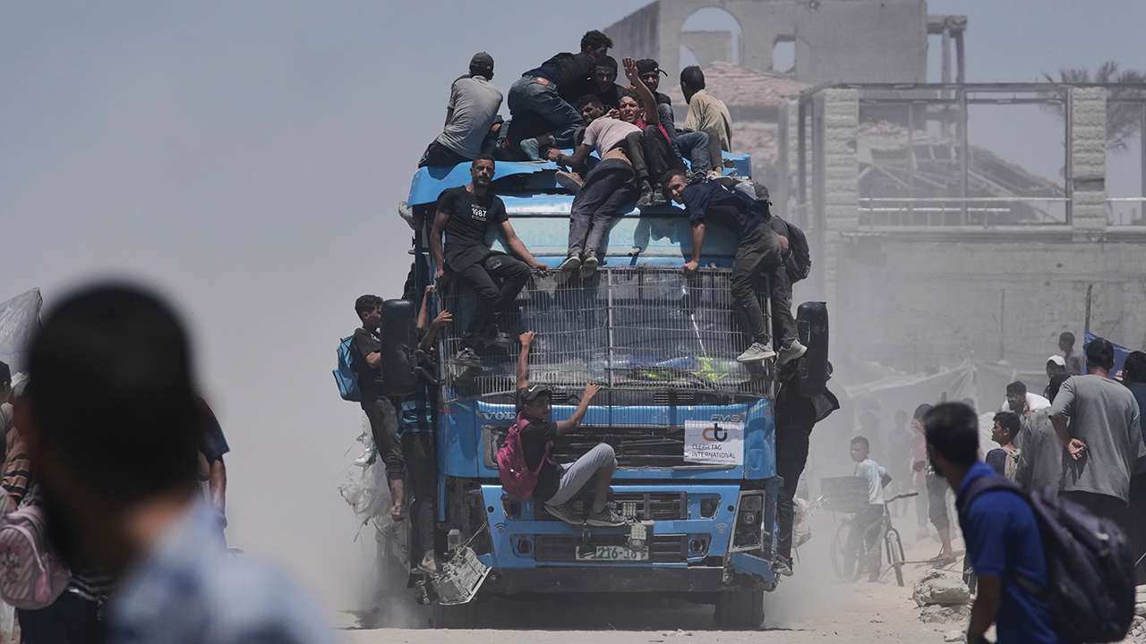 Palestinians hold onto an aid truck returning to Gaza City from the northern Gaza Strip on July 22. — Jehad Alshrafi/Associated Press