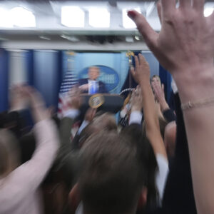 Reporters raise their hands to ask a question as President Donald Trump speaks to the media on June 27 in the briefing room of the White House. — Jacquelyn Martin/AP