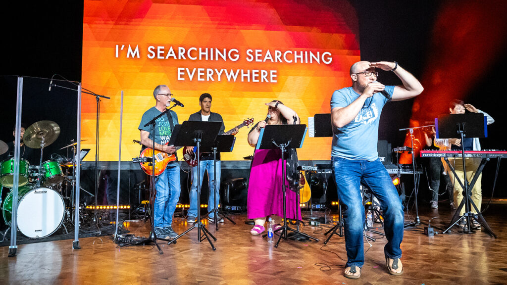 Band leader Randall Koehler leads the crowd in singing “Akekho Ofana No Jesu,” a song about searching everywhere but finding no one like Jesus. Other band members are Hector Martinez on drums and, from left, Lee Ebersole, Samuel Vazquez, Morgan Koehler and Amy Hofer Vetch. Not visible is Chelsea Vaught. — MiccicheCorporate.com for MC USA