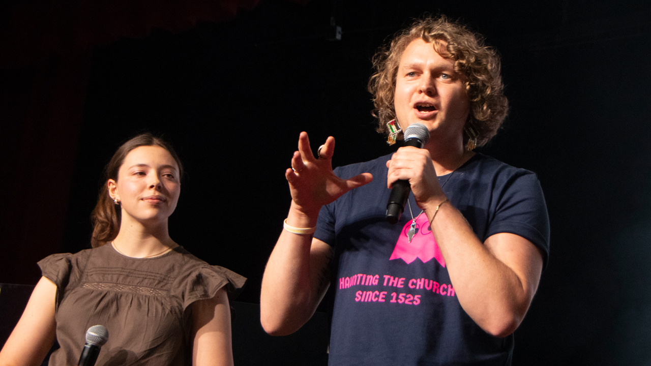 Jay Bergen, pastor of Germantown Mennonite Church in Philadelphia, speaks as Olivia Krall, Mennonite Church USA archives coordinator, looks on. — Juan Moya/AW