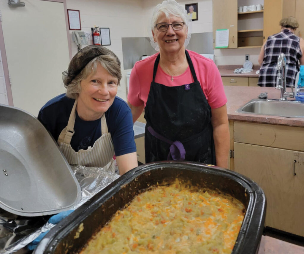 Cooks at the Light on Main Street weekly community lunch in Hanover, Ont., with donated potatoes. — Sierra Ross Richer for AW