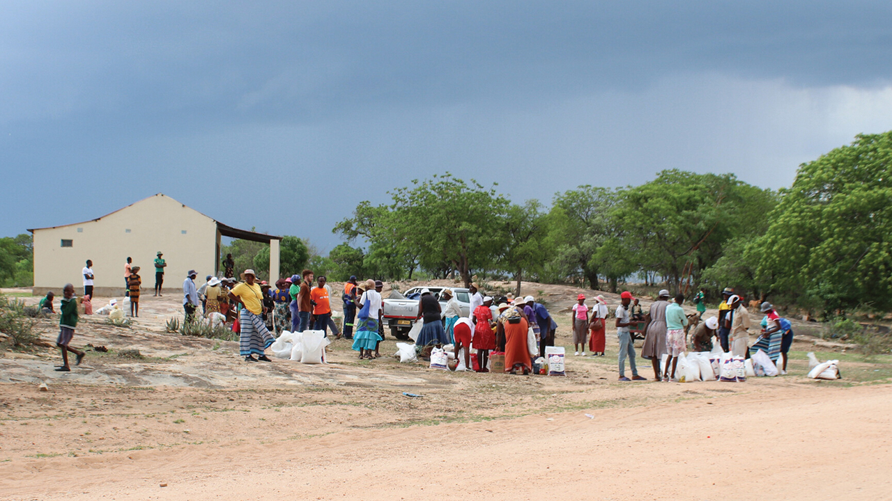 People gathered to receive food from Zimbabwe Brethren in Christ Compassionate and Development Services last November. — Julia Abadia Weaver/MCC