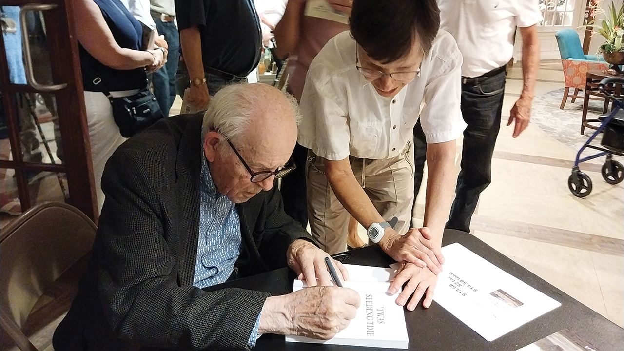 John Ruth signs a copy of the 2025 edition of ’Twas Seeding Time on July 18 at Souderton Mennonite Homes in Pennsylvania. — Eileen Kinch/AW