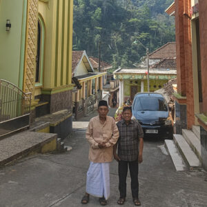 Abu Abdillah, imam of the Nurul Hikmah Mosque, and Suwadi, a leader of the GITJ Tempur Church, stand in the narrow lane that separates the mosque and the church in Tempur, Indonesia. — Danang Kristiawan