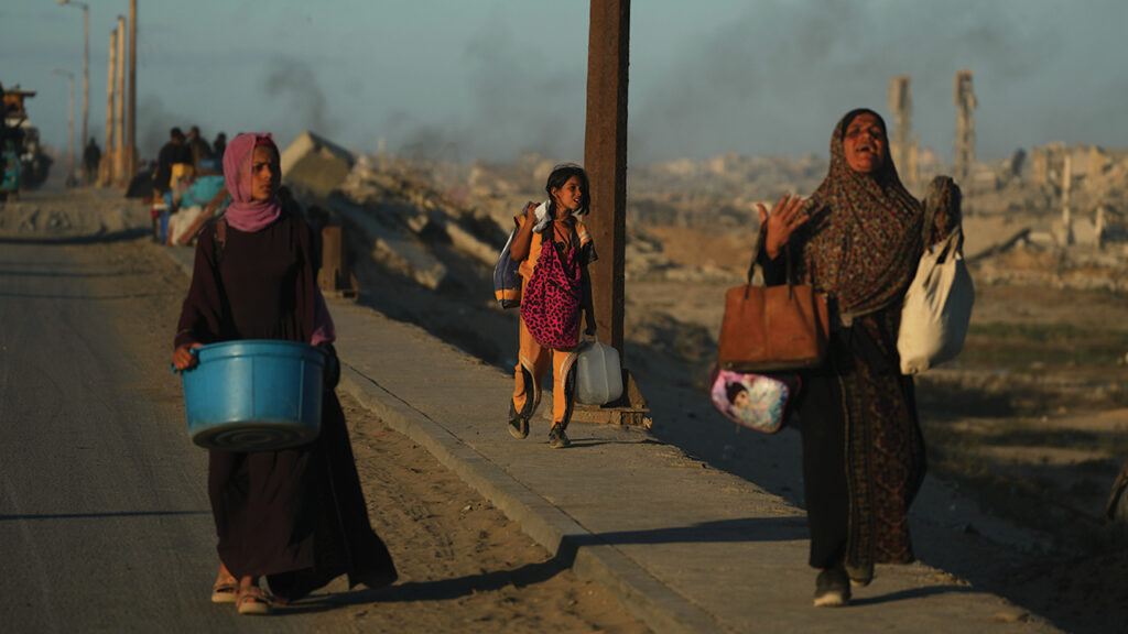 Displaced Palestinians flee northern Gaza carrying their belongings Oct. 1 along the coastal road near Wadi Gaza. — Jehad Alshrafi/AP