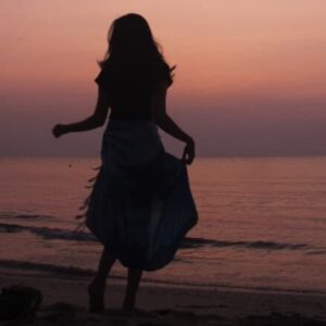 Figure standing before sunset.