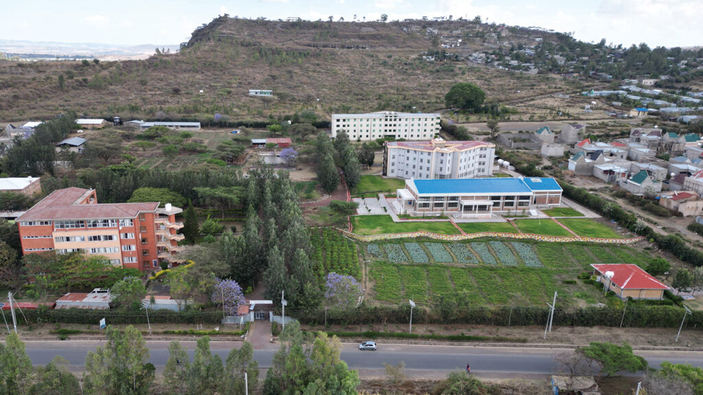 Meserete Kristos Seminary hopes to build a new guest facility in a prominent position along the main road, next to the structure with the red roof. — MK Seminary Newsletter