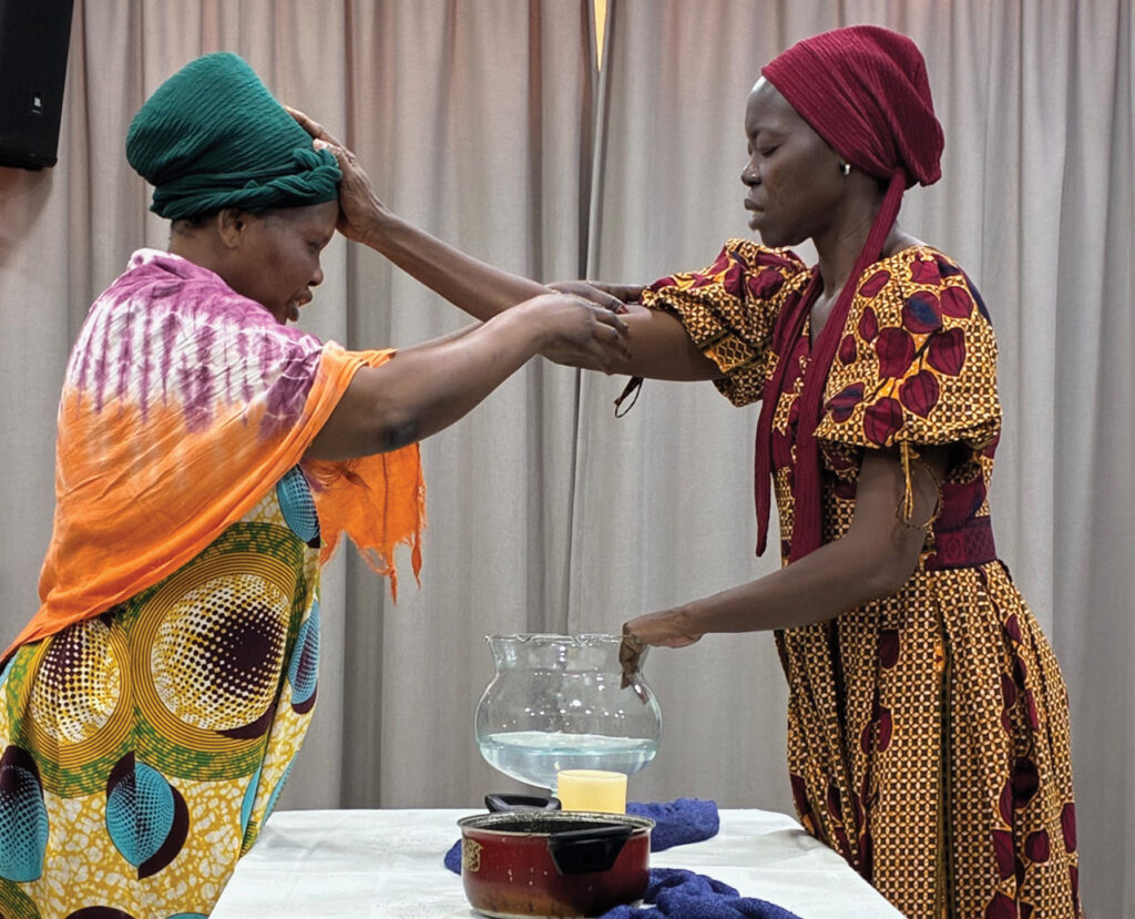 Women anoint each other during the closing ritual. — Carolyn Heggen