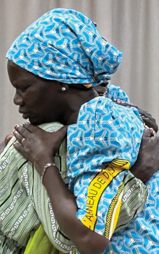Women embrace after the closing ritual. — Carolyn Heggen