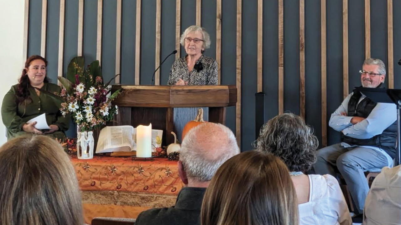 Loretta Lapp, a charter member of Ridgeview Mennonite Church, shares during a rededication service Oct. 26. At left is Katelyn Robbins, pastor of Ridgeview. At right is John Denlinger, church member and former pastor. — Sarah Rohrer