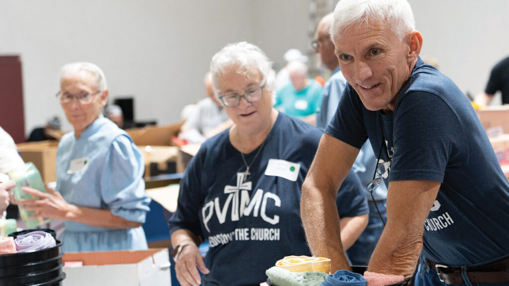Sherry Corrigan and Michael Steigman pack relief kits at Pleasant View Mennonite Church. — Jake Smucker/MCC
