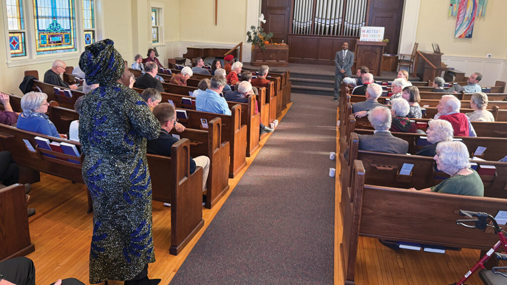 Sibonokuhle Ncube makes a comment from the audience as Drew G.I. Hart listens at Eighth Street Mennonite Church in Goshen, Ind., on Nov. 16. — J Ron Byler