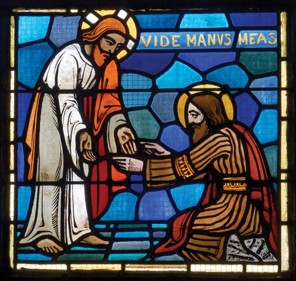 Thomas the Apostle touches the wounds of Christ. Stained glass, Saint-Ouen, France. — Shutterstock